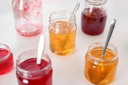 Jars with sweet jams on tableの写真素材