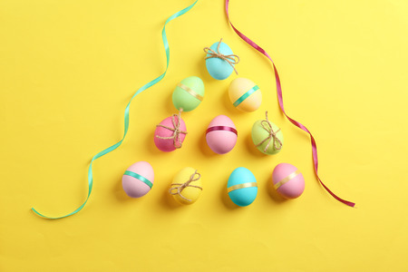 Decorated Easter eggs on color background