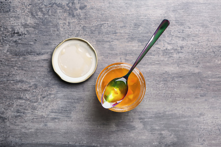 Jar with sweet jam on grey backgroundの写真素材