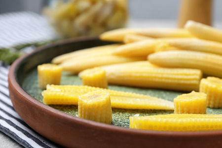 Fresh young baby corn on plate, closeupの写真素材