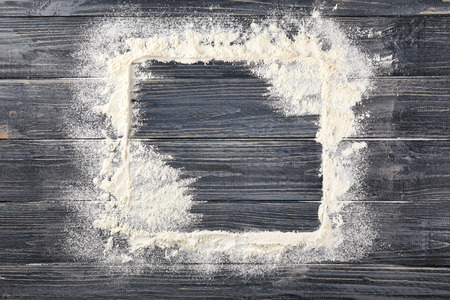 Square frame made of flour on wooden background, top viewの写真素材