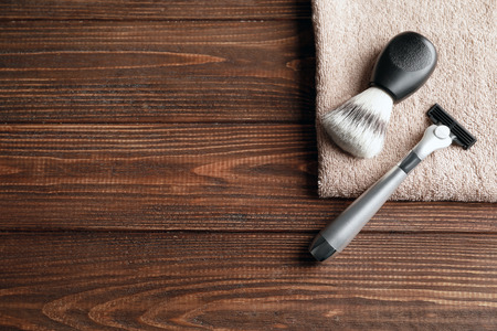Shaving brush, razor for man and towel on wooden backgroundの写真素材