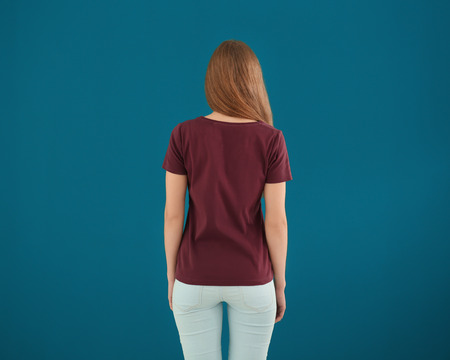 Young woman in stylish t-shirt on color background. Mockup for designの写真素材