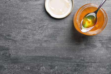 Jar with sweet jam on grey backgroundの写真素材