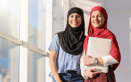 Muslim businesswoman with coworker in officeの写真素材