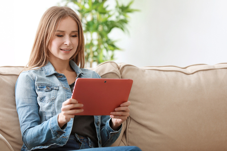 Young woman with tablet at homeの写真素材