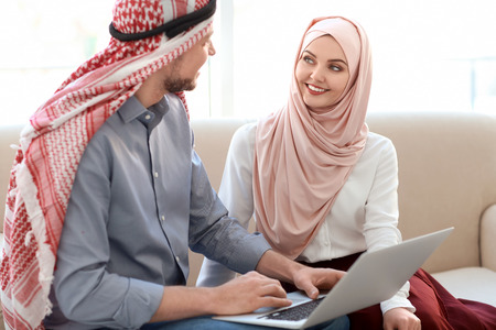 Muslim businessman with coworker in officeの写真素材