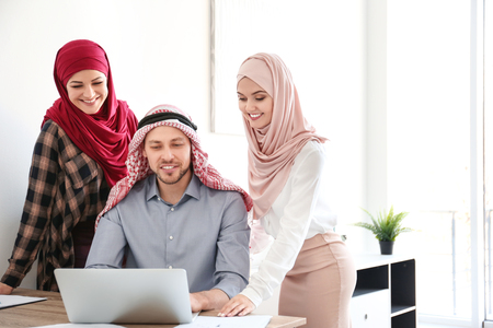 Muslim businessman with coworkers in officeの写真素材