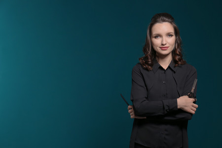Professional hairdresser on color background