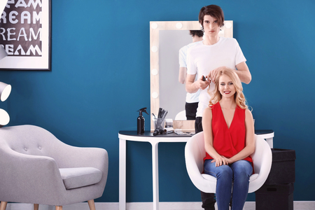 Professional hairdresser working with client in salonの写真素材