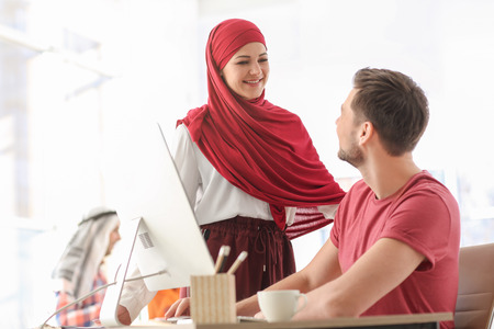Muslim businesswoman with coworker in officeの写真素材