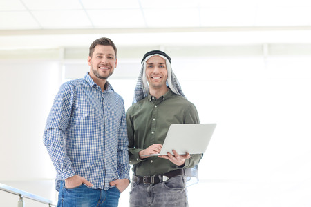 Muslim businessman with coworker in office