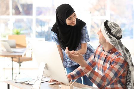 Muslim businessman with coworker in officeの写真素材