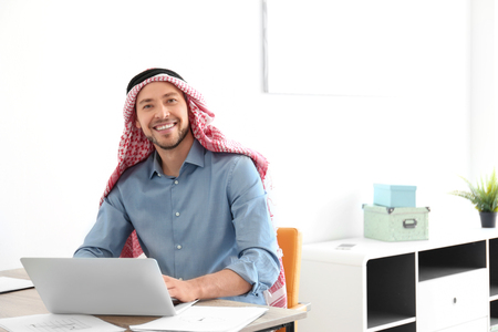 Muslim businessman in traditional clothes at workplaceの写真素材
