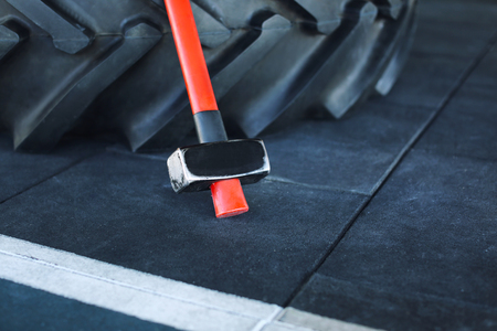 Heavy tire and hammer for training in gymの写真素材