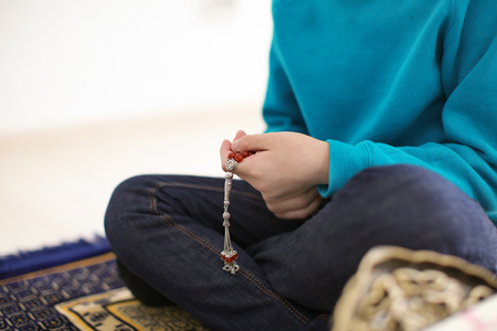 Little Muslim boy praying, indoorsの写真素材