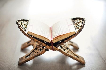 Open holy book of Muslims on standの写真素材