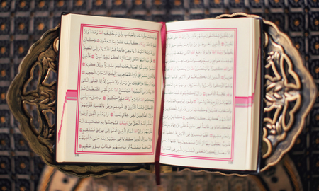 Open holy book of Muslims on stand
