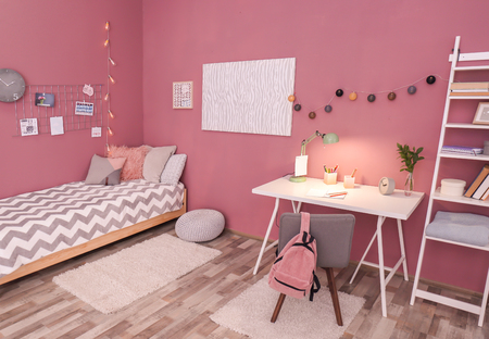 Comfortable bed and desk in modern children roomの写真素材