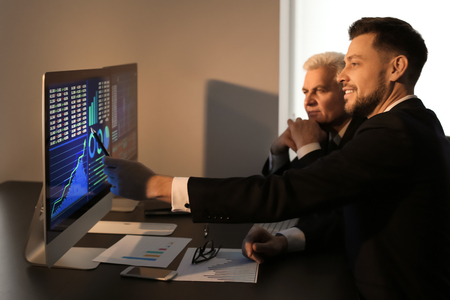 Male brokers working in office. Finance trading conceptの写真素材