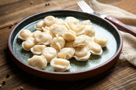 Plate with tasty meat dumplings on tableの写真素材