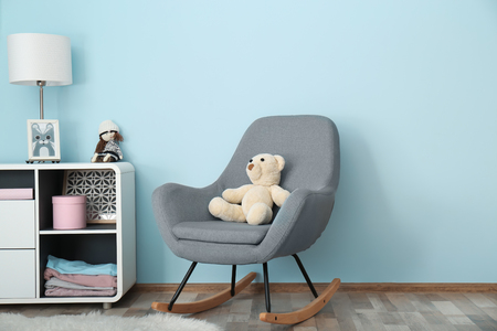 Elegant room interior with comfortable rocking chair near light wallの写真素材