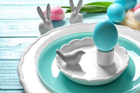 Beautiful festive Easter table setting with painted egg, closeupの写真素材