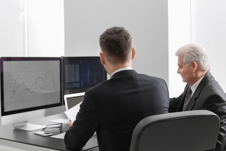 Male brokers working in office. Finance trading conceptの写真素材