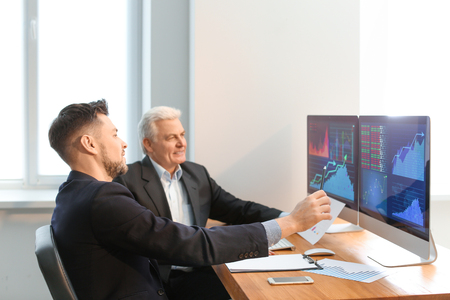 Male brokers working in office. Finance trading conceptの写真素材