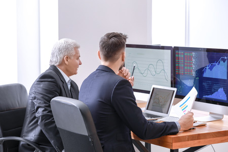 Male brokers working in office. Finance trading conceptの写真素材