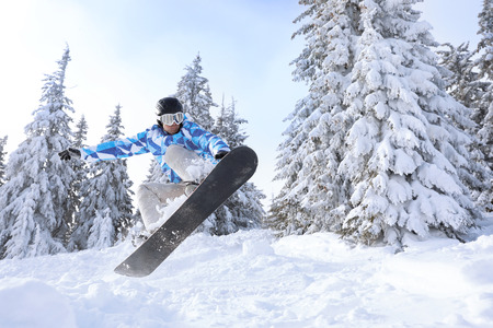Snowboarder on ski piste at snowy resort. Winter vacationの写真素材