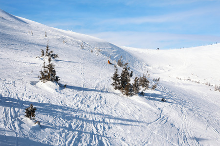 Ski slope at snowy resort on winter day