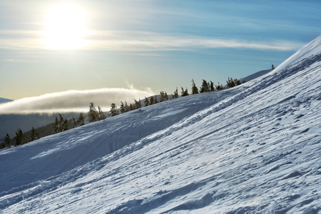 Ski slope at snowy resort on winter day