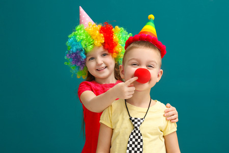 Cute little kids in funny disguise on color background. April fool's day celebrationの写真素材