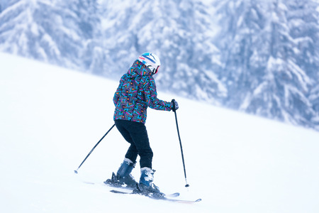 Woman skiing downhill at snowy resort. Winter vacationの写真素材