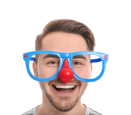 Young man in funny glasses on white background. April fool's day celebrationの写真素材