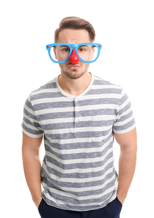 Young man in funny glasses on white background. April fool's day celebrationの写真素材