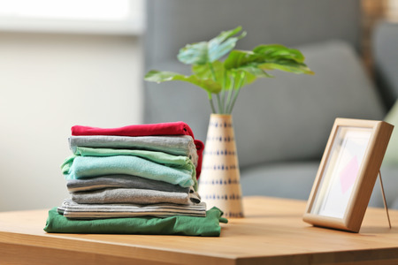 Stack of clothes on wooden table. Laundry dayの写真素材