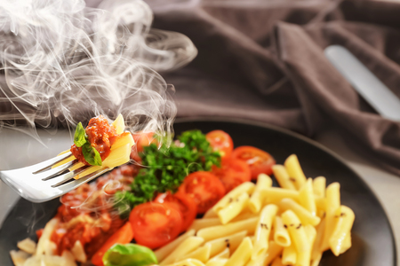 Eating of tasty pasta with bolognese sauce, closeupの写真素材