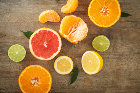 Flat lay composition with ripe citrus fruits on wooden backgroundの写真素材