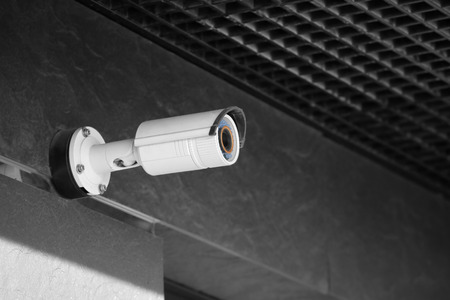 Modern CCTV camera on wall of building outdoorsの写真素材