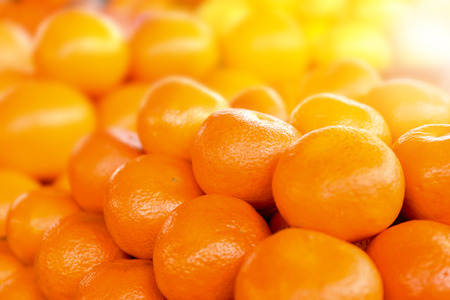 Many ripe tangerines, closeup. Fresh citrus fruit