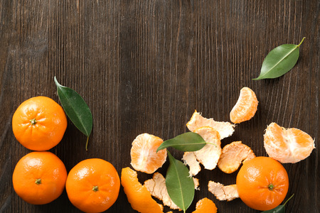 Ripe tangerines on wooden background. Fresh citrus fruitの写真素材