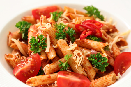 Tasty penne pasta with tomato sauce on plate, closeupの写真素材