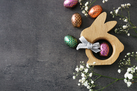 Beautiful composition with Easter eggs and decorative bunny on grey background