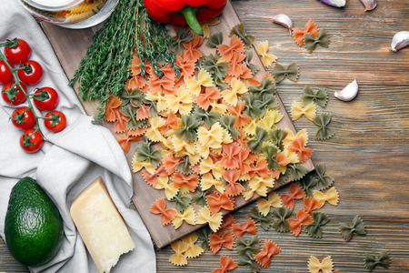 Uncooked pasta and products on wooden backgroundの写真素材