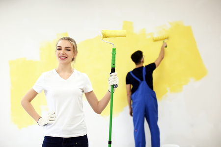 Female decorator with paint roller indoorsの写真素材