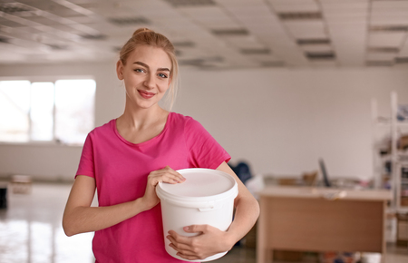 Professional decorator with paint in bucket indoorsの写真素材