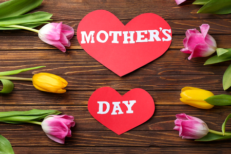 Composition with beautiful tulips for Mother's Day on wooden background, top viewの写真素材