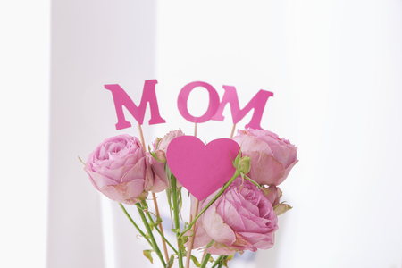 Beautiful bouquet with word MOM on light background. Mother's day celebrationの写真素材